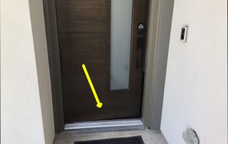 Picture of front door of home that has delaminating at the base of the door found during a home inspection by home inspectors Texan Insspection