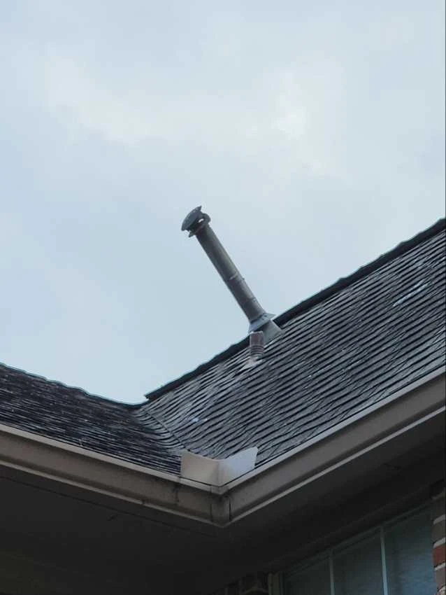 Home Damage: Improper slope at water heater flu causing the potential for moisture intrusion